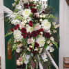Large standing floral spray with white, blush, and burgundy blooms