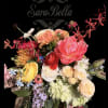 A vibrant, garden-style bouquet featuring lush peonies,elegant roses,ranunculus,hydrangea,and seasonal blooms in soft