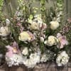 This is a lush, garden-style floral arrangement with a soft, romantic aesthetic.