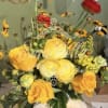 &ldquo;A bright and cheerful arrangement of golden roses and seasonal blooms, designed