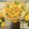 Yellow rose bouquet wrapped in cream paper with butterfly accents
