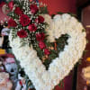 A classic sympathy Heart featuring fresh carnations accented with a beautiful cluster