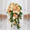 Cascade bouquet of cream and peach roses with pink flowers and greenery
