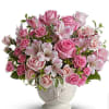 Pink roses and alstroemeria arranged in a white vase