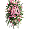 Tall pink and white funeral spray on a stand