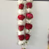 Hanging garland of red roses and white daisies
