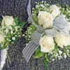White rose boutonniere and matching wrist corsage with silver ribbon