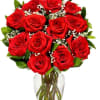 Bouquet of red roses with baby's breath in a clear glass vase