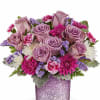 Lavender roses and pink daisies in a glittery purple vase