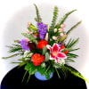 Colorful mixed flower arrangement in a blue vase