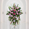 Tall pink and white floral standing spray on an easel