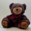 Brown teddy bear with a burgundy ribbon