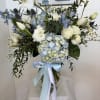 Large white Phalaenopsis orchids take center stage in this Soft Breeze flower