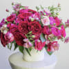 Pink and red rose bouquet in a white vase