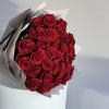 Bouquet of red roses wrapped in white paper
