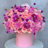 Pink rose and orchid arrangement in a round pink box