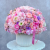 Large pink and lavender bouquet in a white vase with a ribbon
