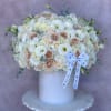 Large white and blush bouquet in a white vase with a ribbon bow