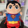 Superman plush toy with a red cape and blue suit