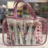 Pink cosmetic bag with four makeup brushes inside