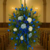 Blue rose funeral spray with white and pale blue flowers