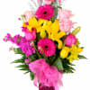 Bright mixed bouquet in a pink vase with a large ribbon