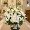 White floral arrangement in a vase inside a church