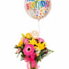 Birthday bouquet with a confetti balloon and pink ribbon in a glass vase