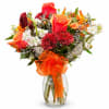 Bouquet of red and orange roses with white flowers in a glass vase