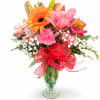 Mixed bouquet in a glass vase with a red ribbon