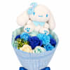 Plush bunny sitting in a bouquet of blue and cream roses