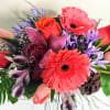 Simple and Elegant Lavender and pink Coral arrangement in silver mercury bowl.