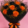 Bouquet of orange and black roses wrapped in black mesh with an orange ribbon