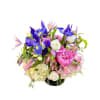 Mixed bouquet of purple, pink, and white flowers in a black vase