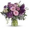 Purple and pink mixed bouquet in a clear glass vase