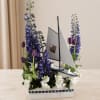 Sailboat centerpiece with purple flowers and white blooms in a white container
