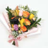 Bouquet of multicolored roses with a graduation cap and chocolates