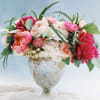 Pink and white flower arrangement in a glass vase