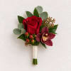 Red rose and burgundy orchid boutonniere with greenery