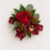 Red rose and burgundy orchid corsage with ribbon