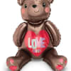 Brown teddy bear balloon holding a heart that says Love You