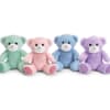 Four pastel teddy bears sitting in a row