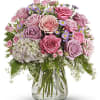 Pink and lavender rose bouquet in a clear glass vase