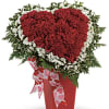 Heart-shaped red carnation arrangement with white flowers and a heart-print ribbon