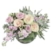 Bouquet of pale pink and cream roses with lavender flowers in a green vase