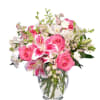 Pink roses and lilies in a clear glass vase