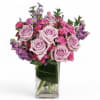 Lavender and pink rose bouquet in a clear glass vase