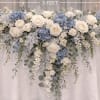 White and blue floral garland draped over a table