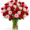 Bouquet of red and pink roses in a clear glass vase