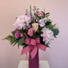 Soft blush peonies anchor this Sweet Pink flower arrangement, making it a